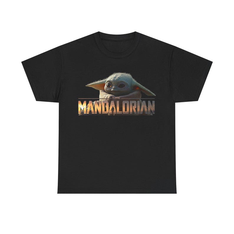 A black t-shirt with a graphic design featuring the character The Child from the Star Wars series The Mandalorian.