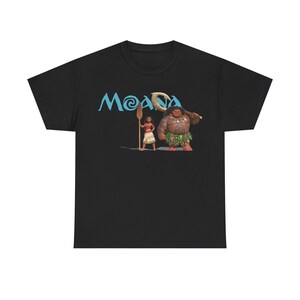 A black t-shirt with a graphic design featuring Moana, a character from the Disney animated film "Moana". Moana is depicted holding a paddle and standing next to a character with a large head.
