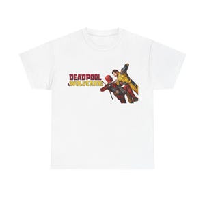 A white t-shirt with a graphic design featuring two characters from the Marvel Cinematic Universe, specifically Deadpool and the Wolverine team.