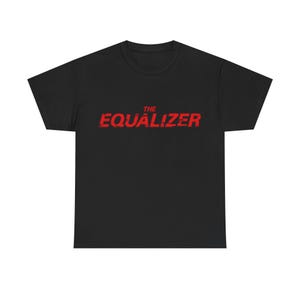 May include: Black t-shirt with the red text "THE EQUALIZER" across the front. The text has a distressed, textured appearance. The shirt is a basic crew neck style.