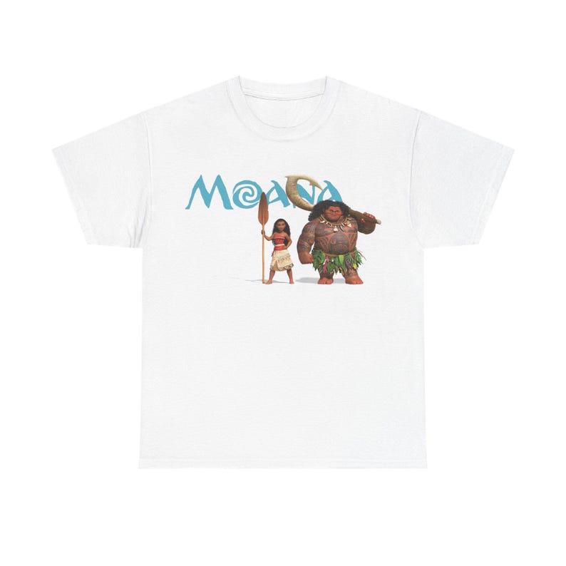 A white t-shirt with a graphic design featuring two cartoon characters, one of which is a woman and the other is a man. The text "Moana" is displayed above the characters.