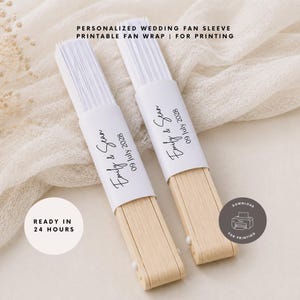 May include: Two folded hand fans with light wood handles and white paper tops. Each fan features a white paper sleeve printed with the text Emily & Sean 09 July 2028. The image includes text stating PERSONALIZED WEDDING FAN SLEEVE PRINTABLE FAN WRAP | FOR PRINTING, READY IN 24 HOURS, and DOWNLOAD FOR PRINTING.