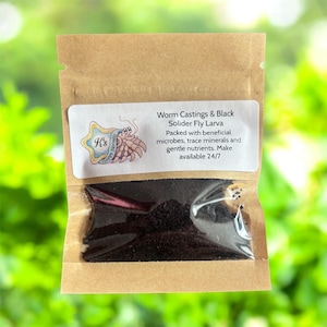 May include: A small, brown paper bag with a clear window containing dark, granular material. A white label displays text: "Worm Castings & Black Solider Fly Larva." The label also includes a logo and additional text about the product's benefits.