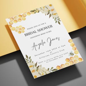 May include: Bridal shower invitation with a bee and honeycomb theme. The invitation features floral accents, the text "BRIDAL SHOWER" and the name "Angela Jones". The date is December 16th, 2023.