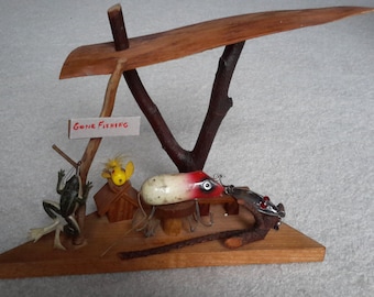 Four Vintage Fishing Lures one Shakespeare Swimming Mouse on wood bench with sticks nice display piece