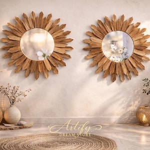 May include: Two sunburst mirrors with wooden frames hang on a neutral wall. The mirrors reflect a soft, natural light. Decorative vases, pampas grass, and a woven rug complete the bohemian-inspired decor. The text "Artify Dream Store" is visible.