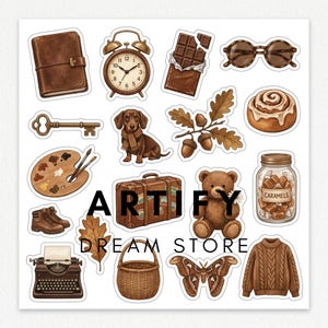 May include: A sticker sheet featuring brown-toned illustrations including a leather journal, alarm clock, chocolate bar, sunglasses, key, dachshund, acorns, cinnamon roll, paint palette, boots, suitcase, teddy bear, caramels, typewriter, basket, moth, and sweater.