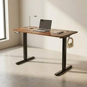 May include: A brown and black adjustable standing desk with a laptop, lamp, and headphones. The desk has a wood grain finish and black legs. The headphones are beige. The desk is approximately 152 cm long.