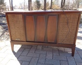 Mid Century Modern Record Player Cabinet with AM FM Radio with built in speakers that are covered in a cane wood finish but does Not Work