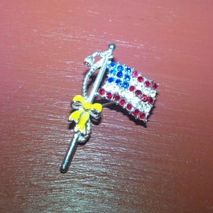 Vintage Rhinestone American Flag Pin with enamel covered yellow ribbon in Very Good Condition