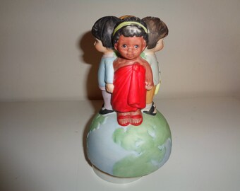 WE ARE The WORLD Musical Playing Ceramic Figurine with Children from across the universe standing on our planet as they go around and around