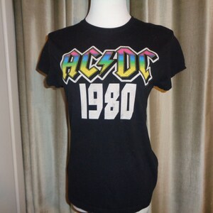 1980 AC/DC Rockware T-Shirt in Very Good Condition which is a reproduction of the original 1980 concert T-shirt, Rock and Roll Lives On!!!!