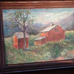 May include: A painting of a red barn with a green roof in a field with a tree and mountains in the background.