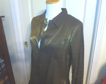 May include: A long-sleeved, button-down shirt in a dark, shimmering bronze color. The shirt has a classic collar and is displayed on a mannequin. The fabric appears to have a subtle sheen, suggesting a silk or satin-like material. The shirt is a formal wear item.