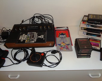 Vintage ATARI Video Computer System complete with an owner's manual, 13 video games, one joystick,  two paddle controllers, AC Power Supply