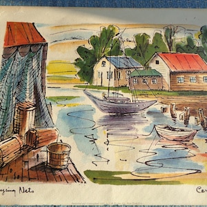 May include: Watercolor painting of a coastal scene with a sailboat, small boat, and buildings. The painting features a dock with barrels and a net, and the text "Drying Nets". The color palette includes blues, greens, and oranges.