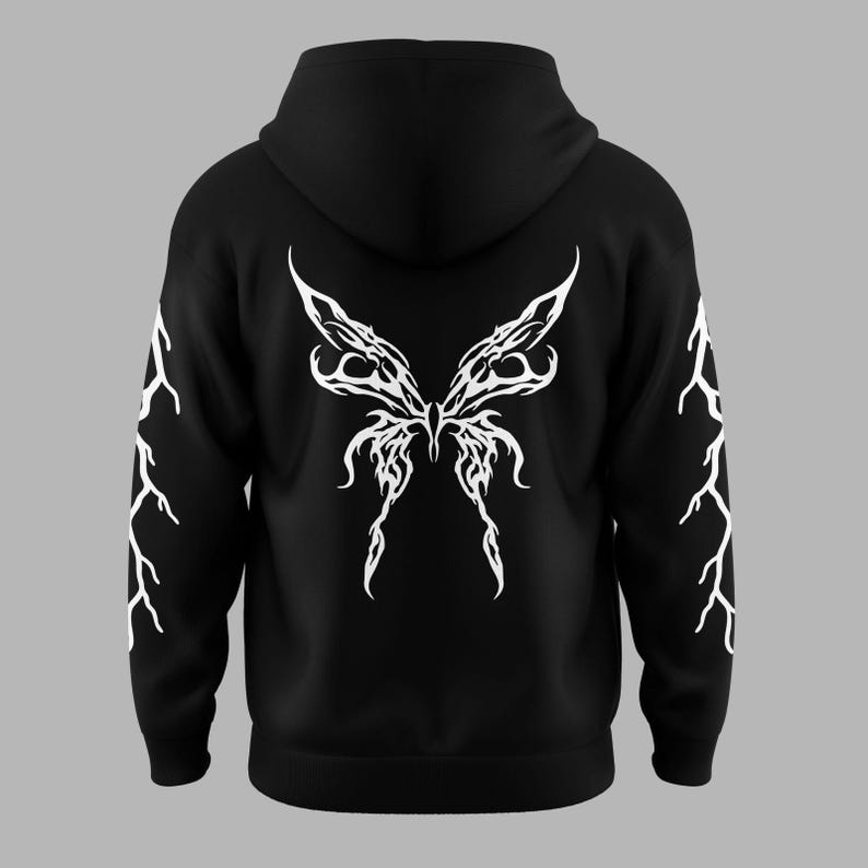 Puede incluir: Sudadera con capucha negra con un dise&ntilde;o de alas de mariposa blancas en la espalda. Las mangas presentan patrones de rayos blancos. La sudadera tiene capucha y un corte holgado.