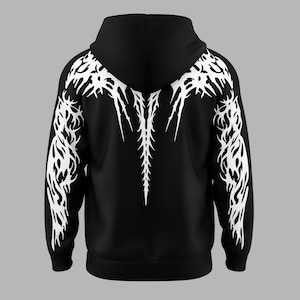 Può includere: Felpa con cappuccio nera con un design tribale bianco. Il design presenta un motivo centrale a forma di spina dorsale che si estende dal cappuccio e si dirama sulle spalle e sulle braccia. La felpa ha un cappuccio con coulisse e un orlo a coste.