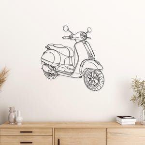 Puede incluir: Un dibujo lineal en blanco y negro de un scooter vintage. El scooter presenta un frente redondeado, un asiento y una sección trasera con un neumático. El scooter está montado en una pared blanca sobre un mueble de madera.