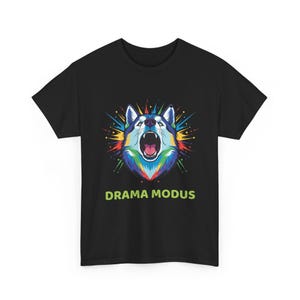 May include: Black t-shirt featuring a colorful illustration of a wolf with an open mouth. The wolf's fur is a mix of blue, green, yellow, and red. The text "DRAMA MODUS" is printed in green below the wolf image.