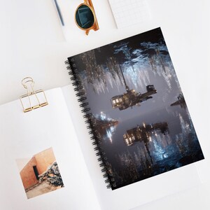 May include: Spiral-bound notebook featuring a futuristic, sci-fi scene with a hovering vehicle over a body of water. The image has a dark, moody atmosphere with reflections and glowing lights. The notebook is open on a white surface.