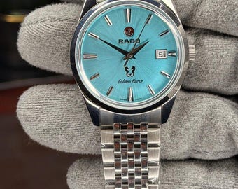 Reloj vintage Rado Golden Horse con esfera turquesa y efecto sol, acero inoxidable y fecha para hombre