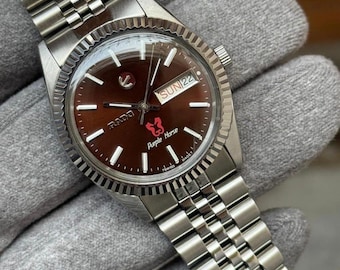 Reloj vintage Rado Purple Horse automático con esfera marrón con efecto sol, acero inoxidable, día y fecha.