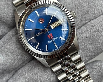 Reloj vintage Rado Purple Horse automático con esfera azul con efecto sol, acero inoxidable, día y fecha.