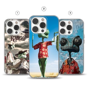 May include: Three phone cases featuring the character Rango from the animated film. The cases display Rango in various scenes, including a desert landscape and a western town. The cases have a clear border and are designed for a smartphone.