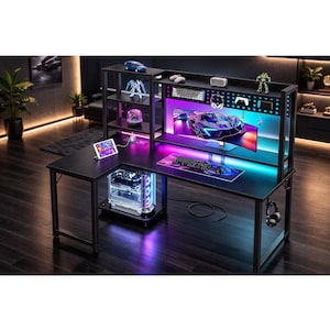 May include: A black gaming desk with a built-in monitor stand and shelves. The desk features a computer tower with LED lights, a keyboard, mouse, and a large monitor displaying a car graphic. Accessories include a tablet, headphones, and decorative figurines.