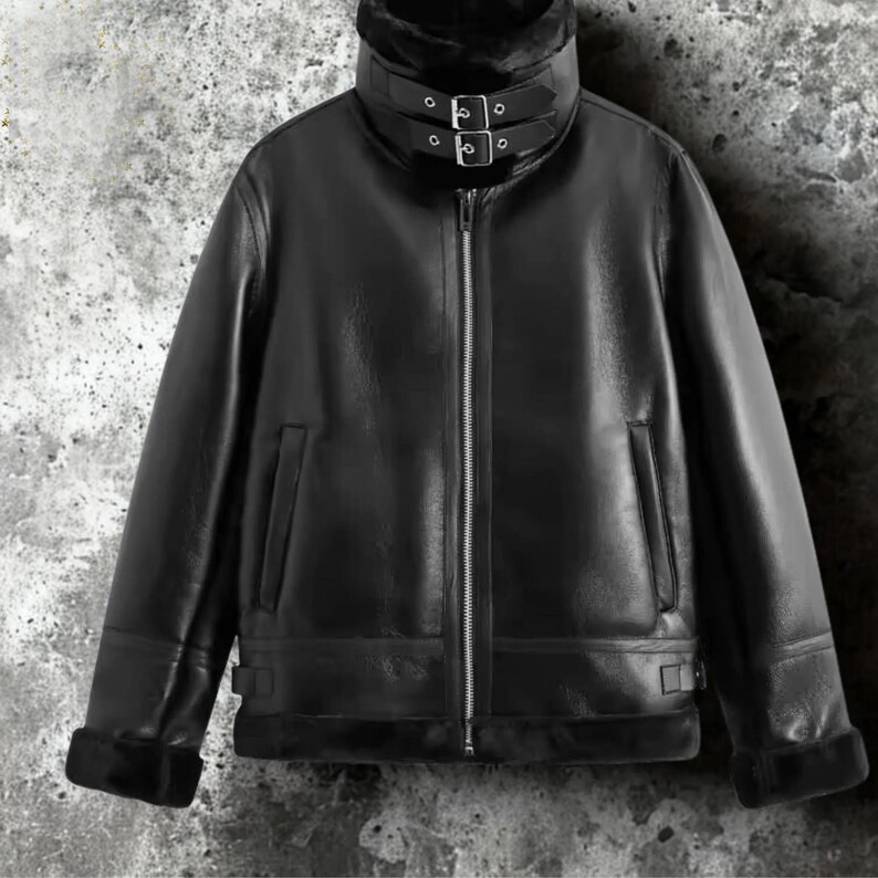 May include: Black leather jacket with a high collar and a faux fur lining. The jacket features a zipper closure, two front pockets, and adjustable buckles on the collar and cuffs. A classic outerwear piece.