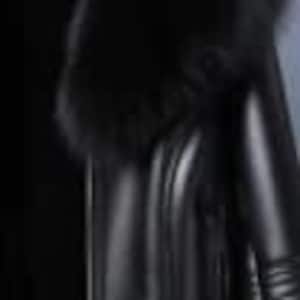 May include: Black faux leather leggings. The leggings have a high waist and a sleek, form-fitting design. The material appears to be smooth and shiny, reflecting light. The leggings are suitable for various occasions.