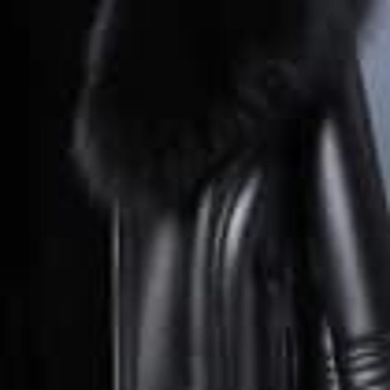 May include: Black faux leather leggings. The leggings have a high waist and a sleek, form-fitting design. The material appears to be smooth and shiny, reflecting light. The leggings are suitable for various occasions.