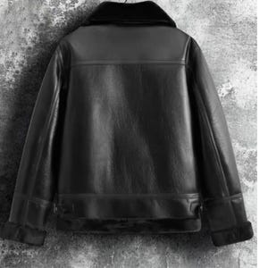 May include: Black leather jacket with a shearling collar and cuffs. The jacket has a classic design with a smooth, glossy finish. The back of the jacket is visible, showcasing the tailored fit and details.