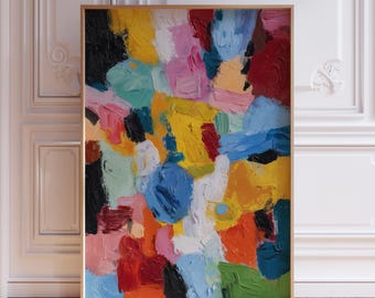 May include: Abstract art print featuring a vibrant mix of colors. The artwork showcases bold brushstrokes in shades of yellow, blue, pink, red, and green, creating a textured and dynamic composition. The painting is framed in a gold-colored frame.