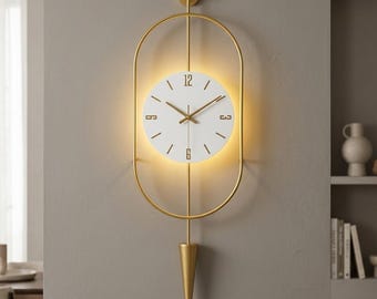 Large Metal Wall Clock with Pendulum, Battery Operated LED Backlit Modern Wall Art, Silent Scandinavian Decor, Gold Oval Luxury Clock