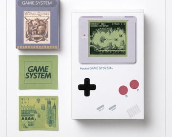 May include: A white handheld game console with a screen displaying a space-themed game, a black directional pad, and two red buttons labeled A and B. Included are three square cards featuring the text GAME SYSTEM and a Royal Quest illustration.