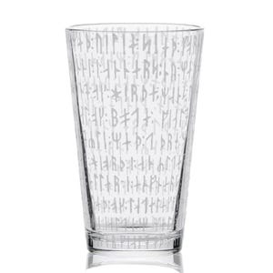 May include: A clear glass pint glass with a straight-sided design. The glass is etched with a pattern of light gray runic symbols. The glass is empty and sits on a white surface.