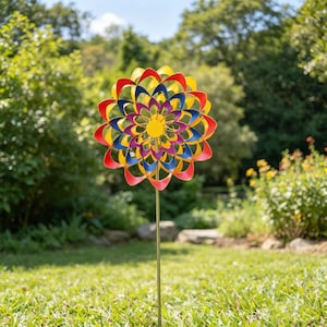 May include: A colorful metal garden spinner with a flower design. The spinner features red, yellow, blue, and purple petals. It is mounted on a thin, gold-colored pole and set in a grassy yard.