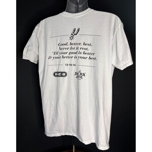 May include: White t-shirt with black text and graphics. The text reads "Good, better, best. Never let it rest. 'Til your good is better & your better is your best." Includes the date 12-18-16 and the logos of H-E-B and Beck Jack.