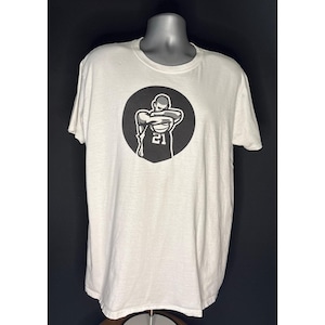 May include: White t-shirt with a black graphic of a basketball player inside a black circle. The player is wearing a jersey with the number 21. The shirt is displayed on a mannequin.