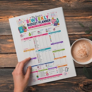 May include: A white paper biweekly budget planner with colorful text and graphics. The cover features the title My Smart BIWEEKLY BUDGET PLANNER, sections for income, expenses, savings goals, and a cash envelope tracker, plus a small piggy bank icon.