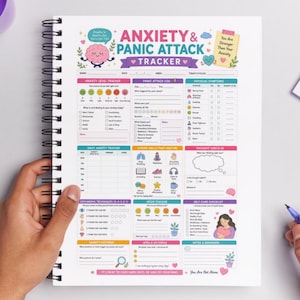 May include: A spiral-bound notebook with an "ANXIETY & PANIC ATTACK TRACKER" design. The tracker includes sections for anxiety levels, panic attack logs, physical symptoms, and daily tracking. The notebook has a pink, purple, and green color scheme.