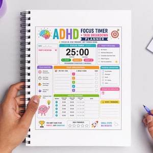 May include: ADHD Focus Timer and Task Breakdown Planner. The white spiral-bound notebook features a colorful layout with sections for focus sessions, task breakdown, and daily progress tracking. The timer displays 25:00 minutes. The text reads "Small Steps, Big Results!"