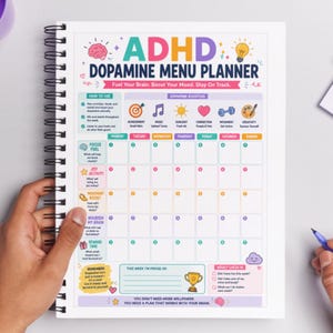 May include: ADHD Dopamine Menu Planner with a spiral binding. The planner features a colorful design with text such as "Fuel Your Brain. Boost Your Mood. Stay On Track." and sections for daily planning and weekly check-ins.