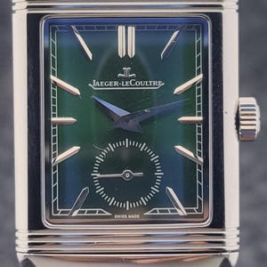 May include: A rectangular Jaeger-LeCoultre watch with a green dial and a green leather strap. The watch face has silver hands and markers, with a small seconds dial at the bottom. The watch is Swiss made.