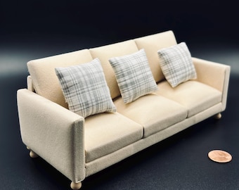 Sofa with 3 plaid throw pillows