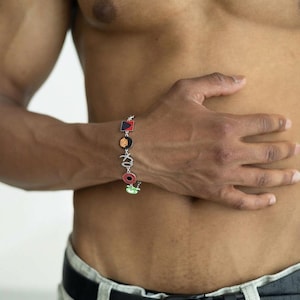 May include: A white ceramic mug with a black handle and the text "But First, Coffee" in a bold, black font. The mug is sitting on a wooden surface. The mug is approximately 4 inches tall.