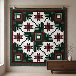 May include: A square quilt featuring a geometric pattern of dark green, deep red, and white fabric pieces. The design includes a central square surrounded by four star motifs and corner blocks, all arranged in a symmetrical, repeating layout.
