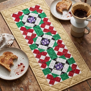 May include: A rectangular quilted table runner featuring a repeating geometric pattern in red, green, white, and purple. The runner has a gold-colored border with a diamond-stitched texture. The central design consists of three star-like blocks.